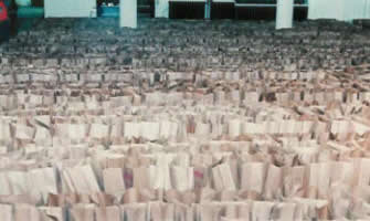 Thousands of grocery bags are lined up ready to be filled with food for the Holiday GiveAways.