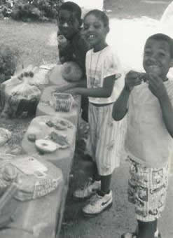 Children got fresh melons, strawberries and bread and held a picnic on the church wall.