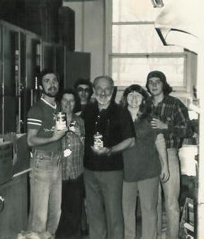 Pastor Paul S Arnopoulos with church member volunteers display canned food colleced from the 1st FoodDrive in 1983.