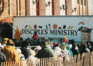 Peaople are lined up and ready to enter the church building for the Easter Holiday GiveAway many of them filled out our survey.