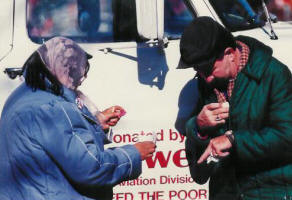 Rosalie, a church volunteer, gives coffee to Ralph who is disabled.