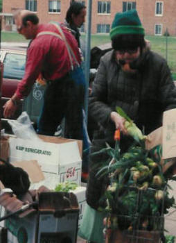 Senior fills her grocery cart with fresh produce from the Street GiveAway.