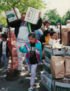 Families take home cases of fresh produce from the Street GiveAway.