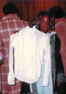 A young girl finds a blouse at the Clothing Closet.