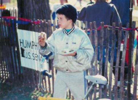 Young boy with his bike eating food at the Voter Registration Picnic at Farview Park in 1986.