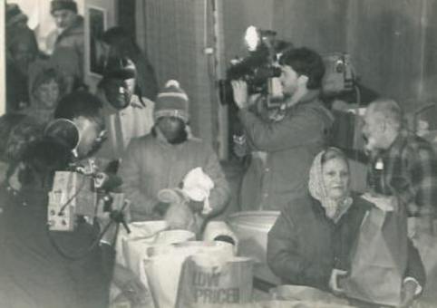 The TV cameras are recording the lines of people at the Thanksgiving GiveAway in 1984.