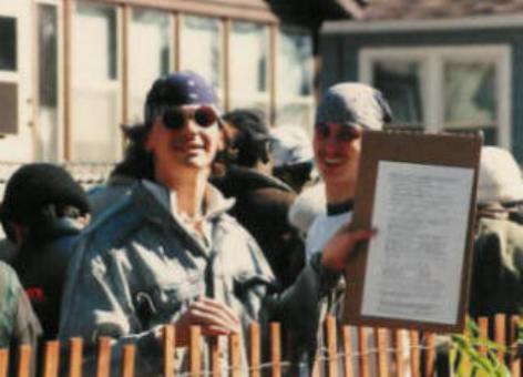 Two men proudly display a completed survey.